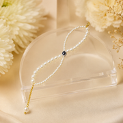 Elegant Pearl Bracelet with Gold Chain & Black Evil Eye Charm